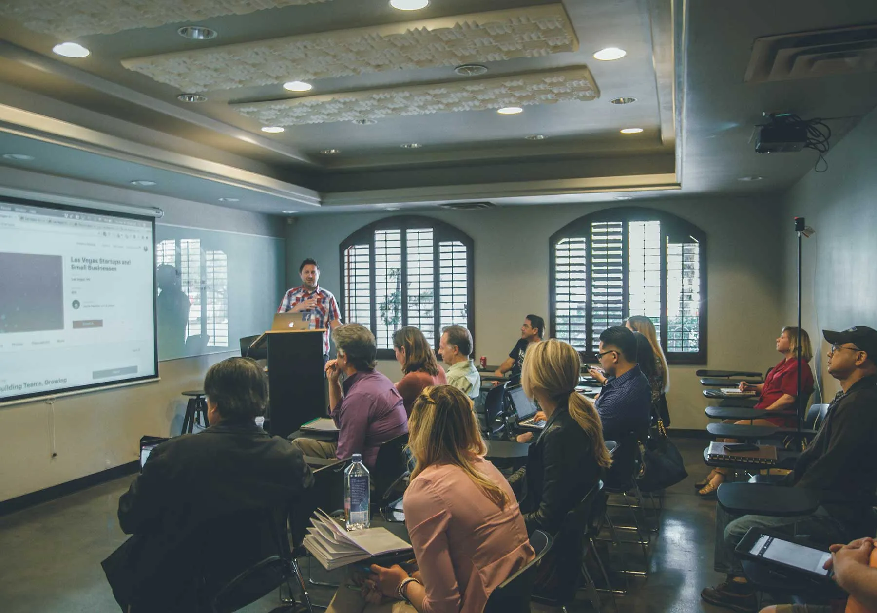 A speaker addressing a group of people